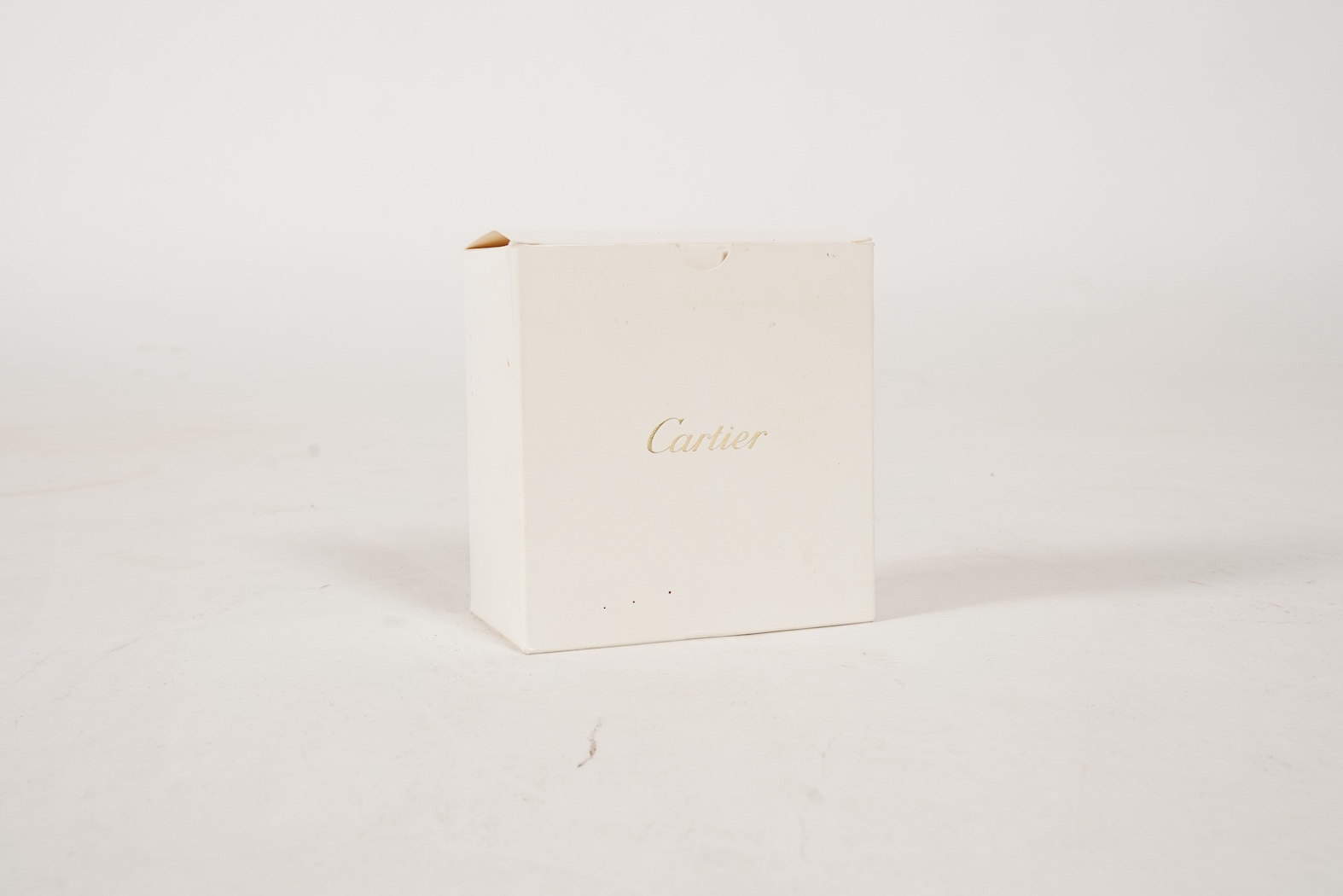 A recent Cartier paperweight, modelled as a panther upon a blue glass sphere